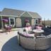 Eo Bungalows in Custer: outdoor courtyard with curved sectional seating, fire pit table, and flower pots