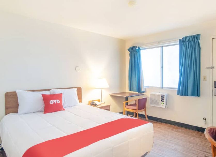 Budgetlodge in Oklahoma City guest room with bed, desk, chair, window and air conditioner