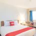 Budgetlodge in Oklahoma City guest room with bed, desk, chair, window and air conditioner