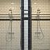 West Village Eurohostel, New York: twin tiled shower stalls with frosted glass doors