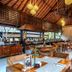 The Lokha Ubud Resort, Villas & Spa in Ubud, open-air restaurant with wooden tables and hanging lights