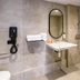 Campanile Nature - Cahors bathroom with walk-in shower, wall-mounted sink, mirror, and towel bars