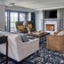 The Grand Hotel Golf Resort & Spa, Point Clear lounge with fireplace, seating area and patterned carpet