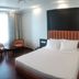 Hotel Heritage Inn Coimbatore guest room with double bed, seating area and window