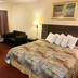 Scottish Inns Mcminnville room with bed, sofa, table and lamp in McMinnville