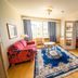 Karolineburg Manor House Hotel in Kajaani guest room with colorful sofa, blue rug, and sitting area