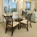 Crystal Towers Gulf Shores condo living area with dining table, sofa, and balcony ocean view