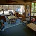 Up The Creek Backpacker's Lodge in Roberts Creek lounge with dining table, sofa, and large windows