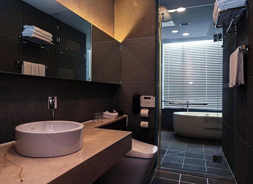 Holiday Inn Gwangju, Korea By IHG bathroom with vessel sink, walk-in shower and soaking tub