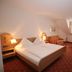Hotel-Restaurant Hirsch in Berghaupten guest room with double bed, striped seating and bay window