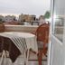 Best Life Apart Hotel Alanya balcony with wicker chairs and table overlooking city buildings