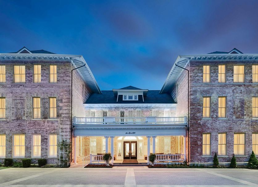Inn at Carnall Hall in Fayetteville, exterior of historic brick hotel at dusk