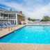 InnSeason Resorts Captain's Quarters in Falmouth: outdoor pool with lounge chairs and clear blue sky