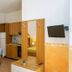 Agriturismo Serafina in Otranto, room with kitchenette, dining table, wall-mounted TV and bed