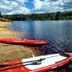 Hotel Heikenberg in Bad Lauterberg: red kayaks on a lakeshore beside clear water and forest