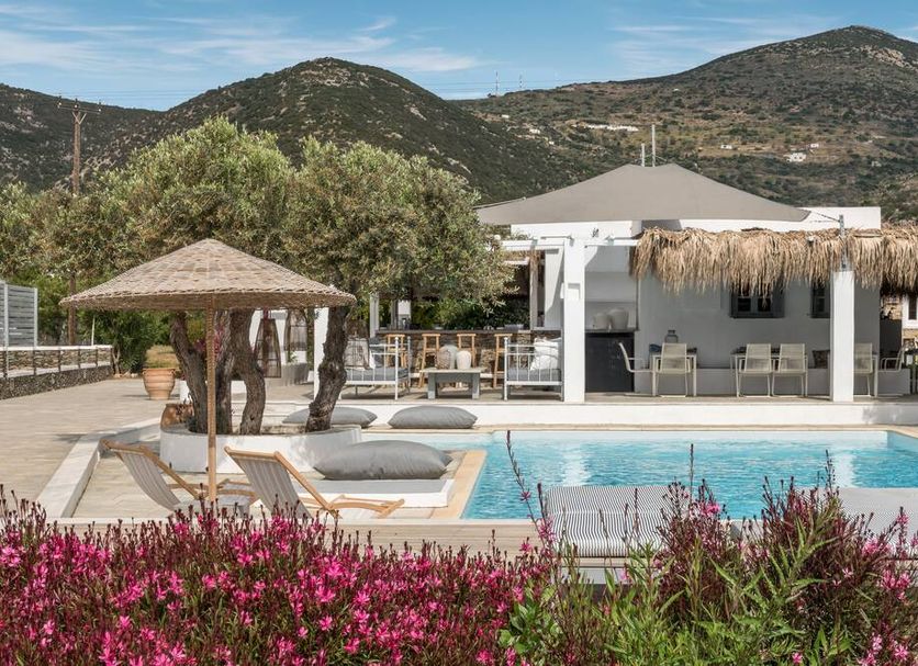 Verina Terra in Platis Gialos with pool, sun loungers, thatched cabana and mountain backdrop