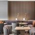 AC Hotels by Marriott Bologna lounge with curved seating, tables, and wall art in a modern lobby
