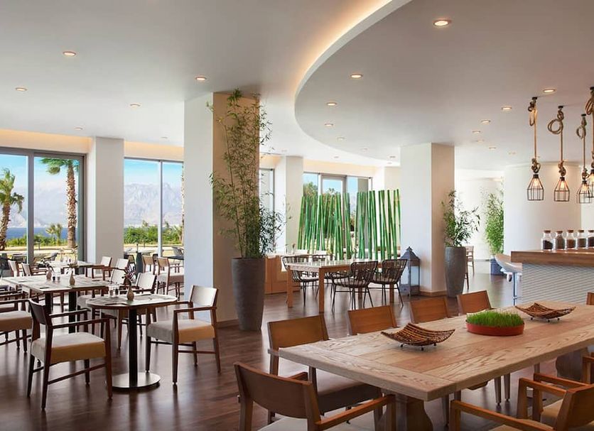 Akra V Hotel Antalya dining room with sea view, floor-to-ceiling windows and modern tables