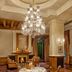 Wildflower Hall, An Oberoi Resort, Shimla lounge with chandelier, fireplace and round dining table