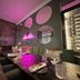 Hotel Am Schloss Ahrensburg lounge dining area with neon sign, mirrored wall accents, and set table