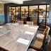 Dining room at The Bluebird Inn at Samlesbury in Blackburn with a large wooden table and glass partition