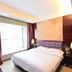 Oriental Hotel Dongguan guest room with double bed, window and curtains