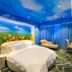 Longwan Hotel (Foshan Ceramics City) room with tulip mural, blue sky ceiling, and chaise lounge in Foshan