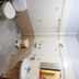Hotel Avtar, Ludhiāna: bathroom with toilet, sink, shower, and tiled walls