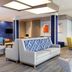 Holiday Inn Express & Suites Cincinnati Se Newport By IHG lobby seating area in Bellevue with colorful wall art