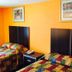 Scottish Inn & Suites Hobby Airport Houston guest room with two double beds and orange walls