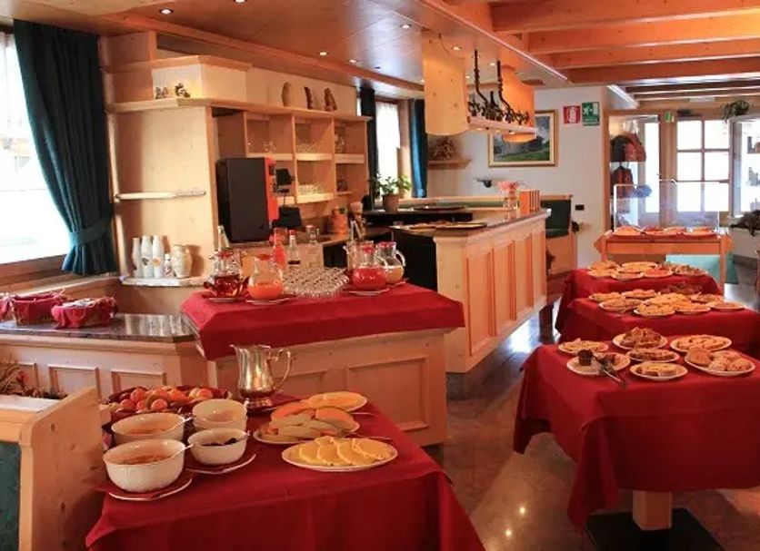 Hotel Victoria, Livigno: breakfast buffet with tables of pastries, fruit, and dishes in a cozy dining room