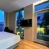 Aloft Seoul Gangnam guest room with large windows, city view, and wall-mounted TV in Seoul