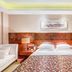 Grand Metropark Hotel Shangqiu guest room with king bed, bedside lamps and sofa in Shangqiu