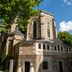 Sozo Hotel Nantes: historic stone hotel building with arched windows beneath leafy trees and blue sky