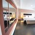 Hotel La Villette in Antananarivo: bright guest room with a bed, sofa, desk, and large window