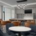 Homewood Suites by Hilton Portsmouth Downtown lounge with round tables, chairs and wall-mounted TV in Portsmouth