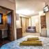 Mediterranean Holidays in Ierissós guest room with bed, sofa, TV and bathroom entrance