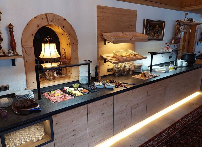 Hotel Stülzis in Lech am Arlberg buffet counter with pastries, fruit and warm lighting