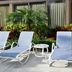 Holiday Inn Express Boca Raton-West by IHG poolside lounge chairs and tropical landscaping in Boca Raton