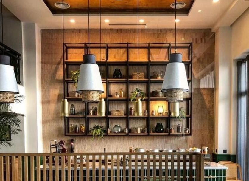 Onomo Hotel Rabat Terminus dining area with banquette seating, hanging pendant lights and open shelving