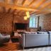 Le Clos Loret in Saint-Germain-du-Corbéis: rustic lounge with stone walls, fireplace, and gray sofas