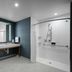 Courtyard by Marriott Delray Beach bathroom with double vanity and roll-in shower in Coral Springs