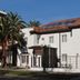 Oporto Hotel Boutique in Santiago, white boutique hotel with red tile roof and palm trees