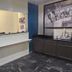 Super 8 by Wyndham Kenedy lobby check-in desk with dark cabinetry and blue walls in Kenedy