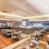 Pestana Curitiba restaurant dining room with tables, buffet counter and warm lighting in Curitiba