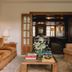 Château Voltaire in Paris lounge with velvet sofa, armchairs and doorway to a dark wood dining room