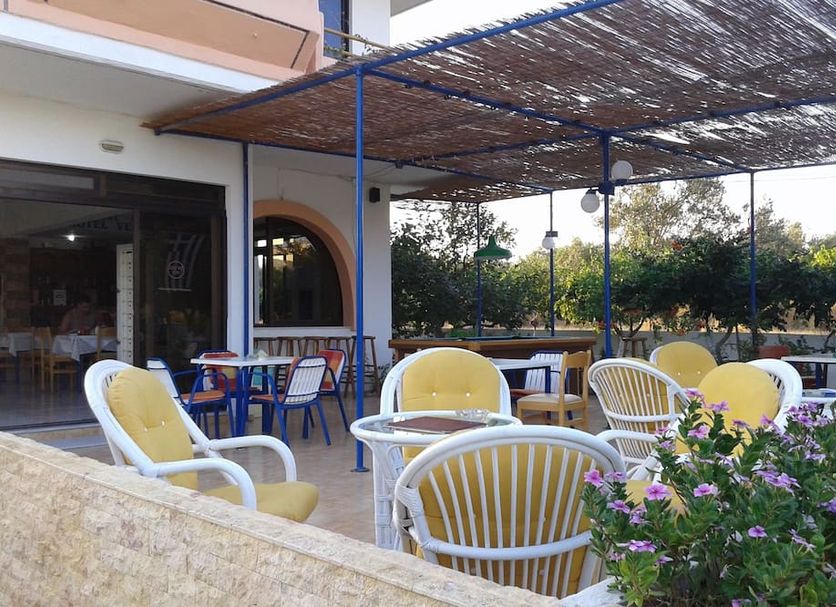 Vera Studios in Faliraki outdoor terrace with wicker chairs, tables and flowering plants