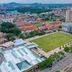 Aerial view of Hotel Suria Malaqa in Malacca beside a large green field and city buildings
