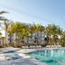 Plunge Beach Resort in Lauderdale-by-the-Sea with palm-lined outdoor pool and sun loungers