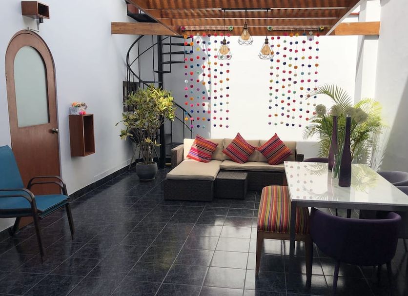 The Lighthouse Bed and Breakfast Lima patio with seating area, spiral staircase and potted plants